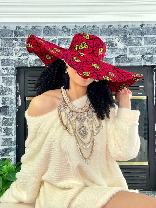 Woman wearing a large red patterned hat.