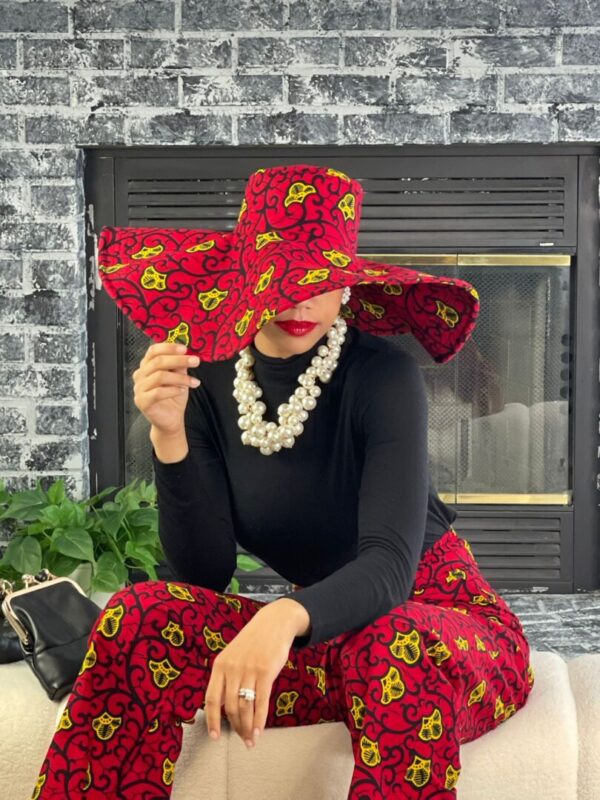 Woman wearing a red and yellow patterned hat.