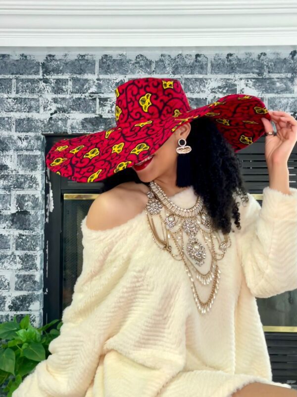 Woman wearing red and yellow patterned hat.