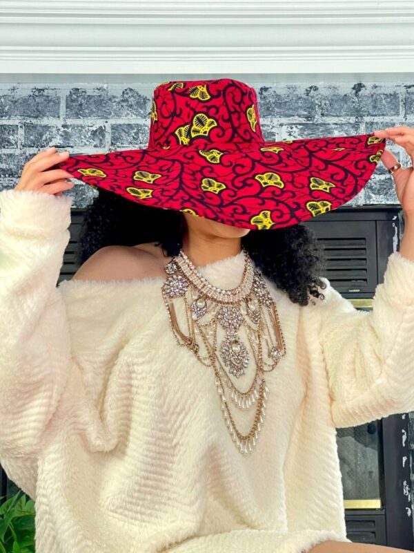 Woman wearing a red and yellow hat.