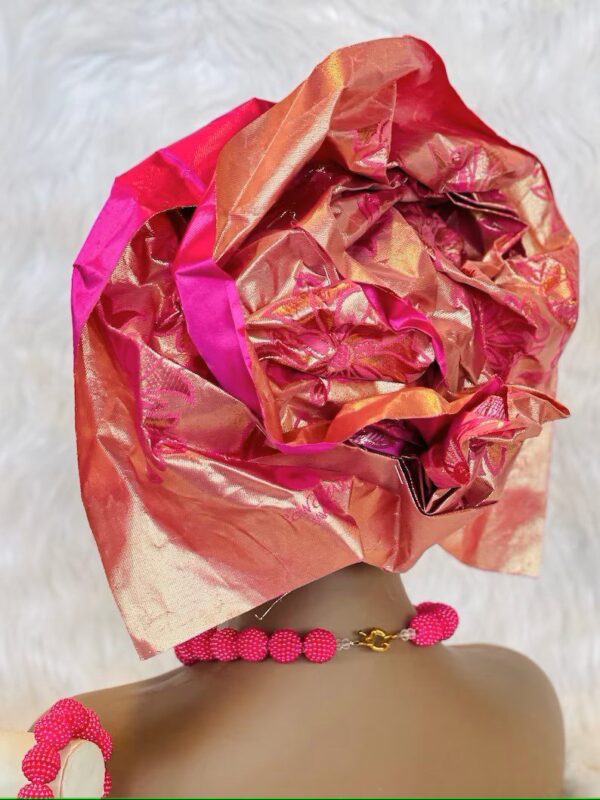 Pink and gold headwrap with beaded necklace.