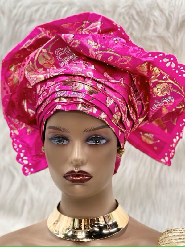 Woman wearing pink headwrap with gold accents.