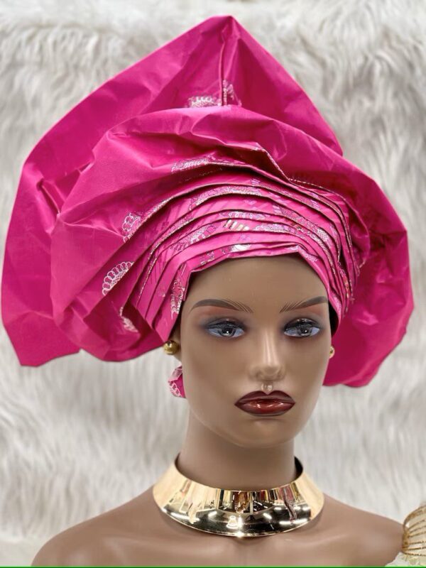 Pink head wrap with gold necklace.