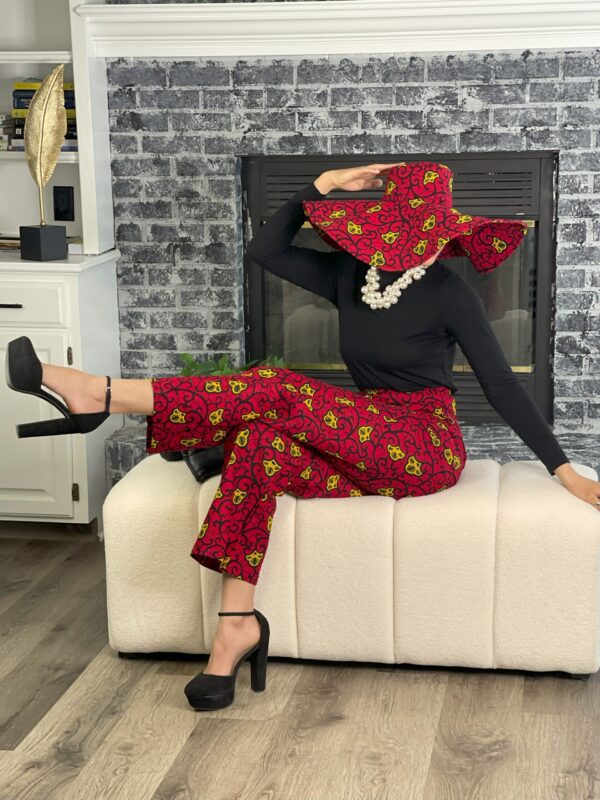 Woman in red pants and a large hat.