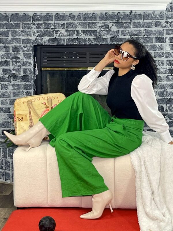 Woman in green pants and white boots.