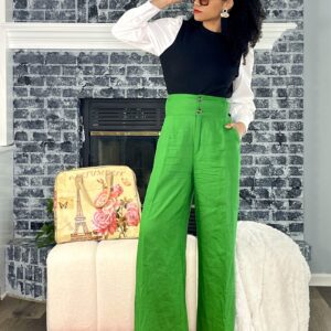 Woman in green pants and white top