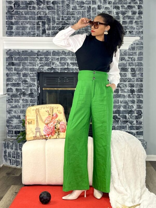 Woman in green pants and white top