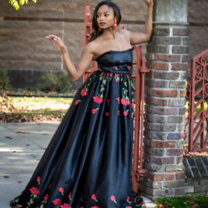 A woman in a black dress posing for the camera.