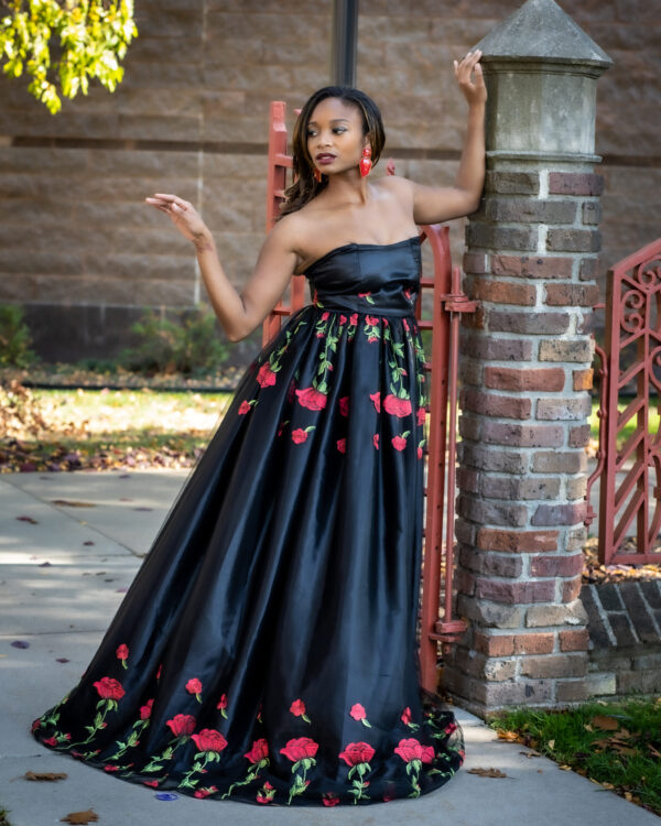 A woman in a black dress posing for the camera.