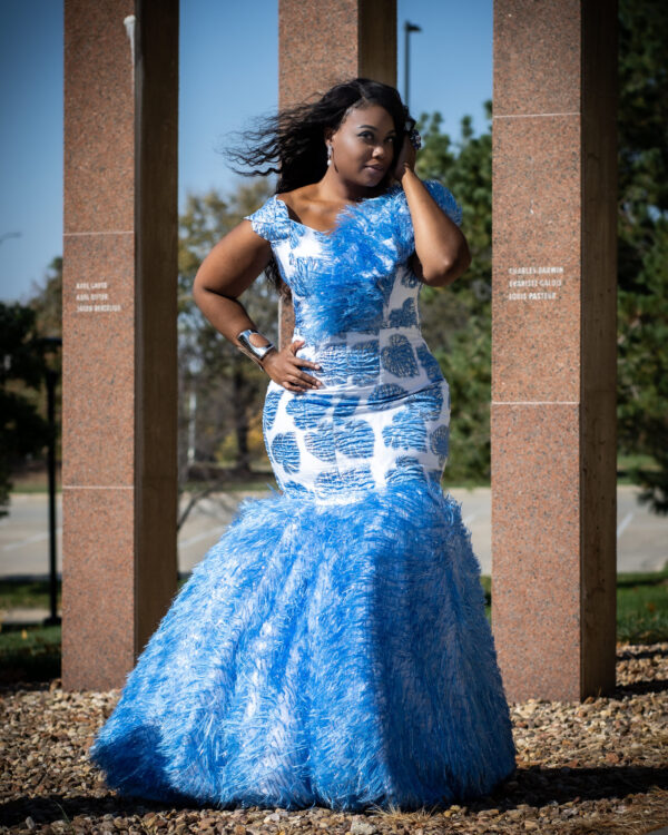 Woman in blue and white dress standing