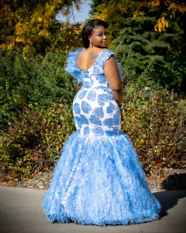 Woman in blue and white dress turning away.