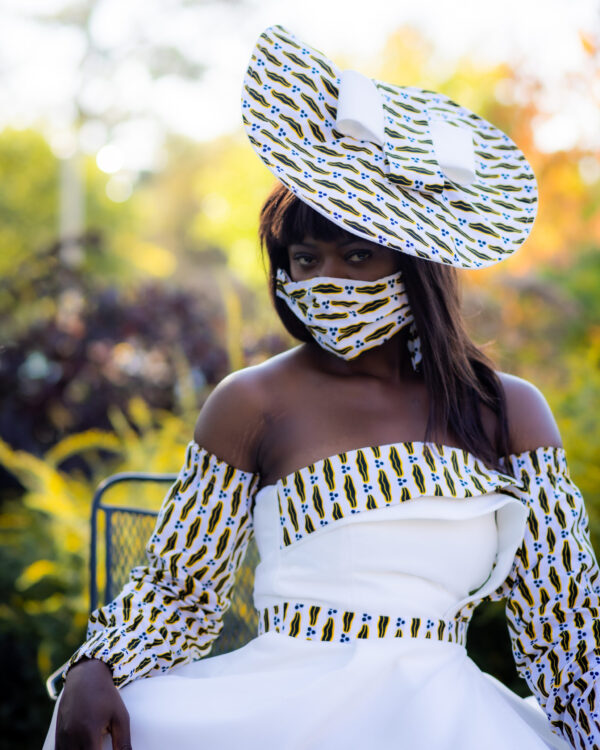 Woman in a white dress and face mask.