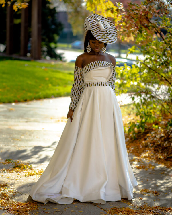 A woman in a white dress and hat