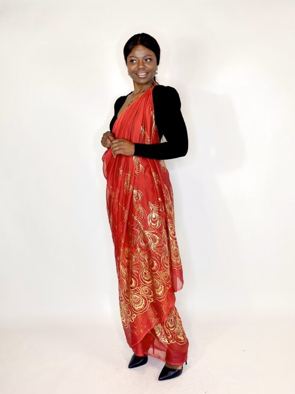 Woman wearing a red and gold sari.