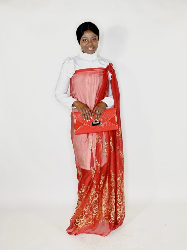 A woman in red and white dress holding a purse.