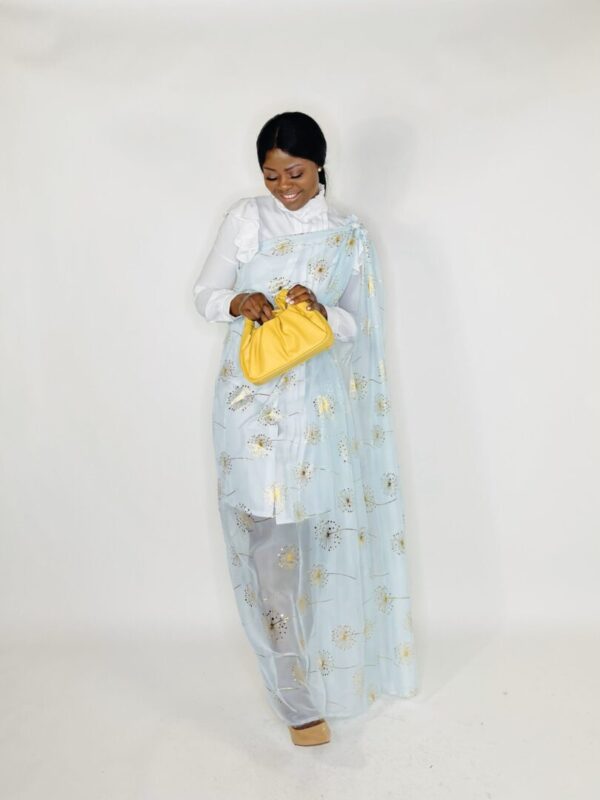 Woman in blue dress with gold dandelions.