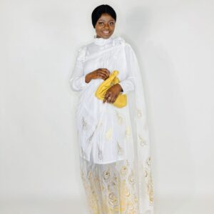 Woman in white dress with gold peacock design.