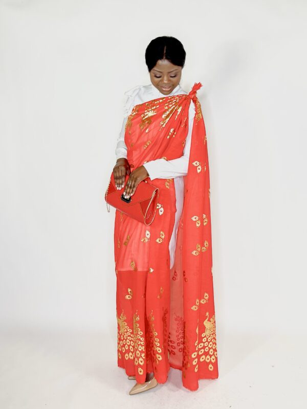 Woman in red saree with gold peacock design.