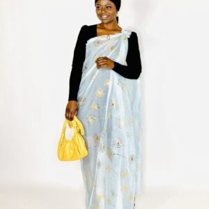 Woman in blue dress with gold dandelions.