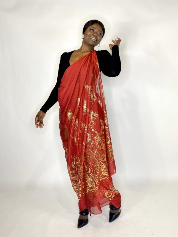 Woman in a red and gold saree.