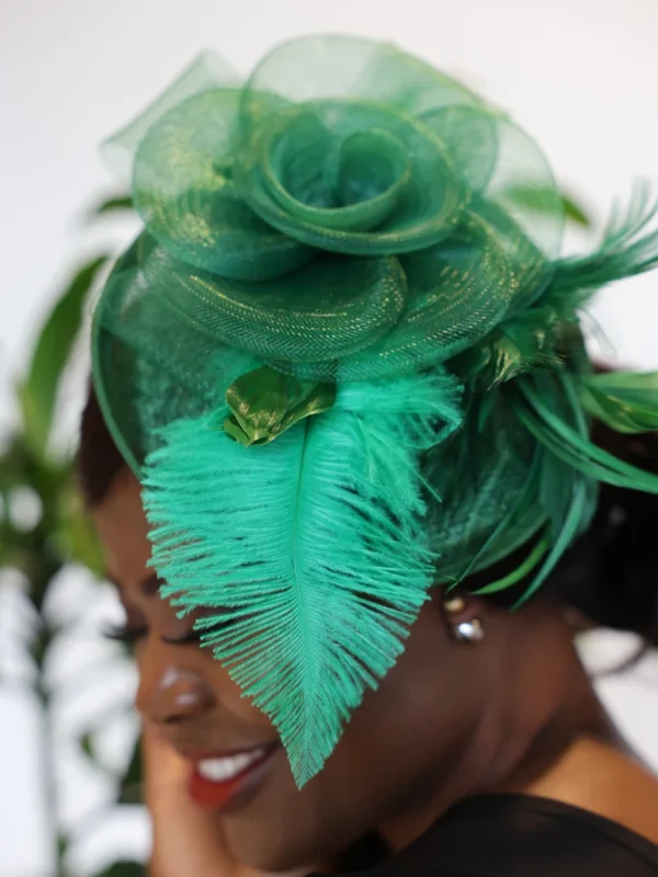 Woman wearing a green feathered hat.