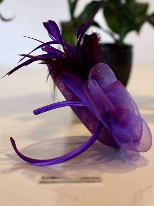 Purple headband with feathered flower.