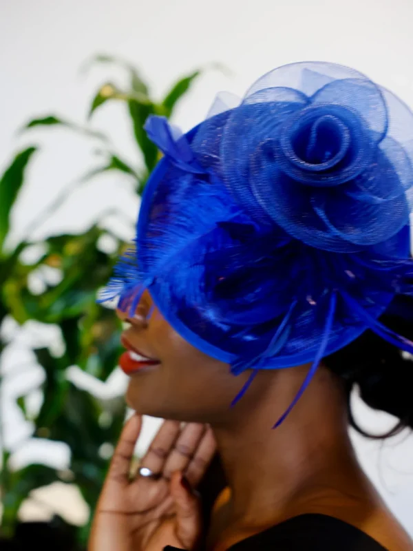 Woman wearing a blue feathered hat.