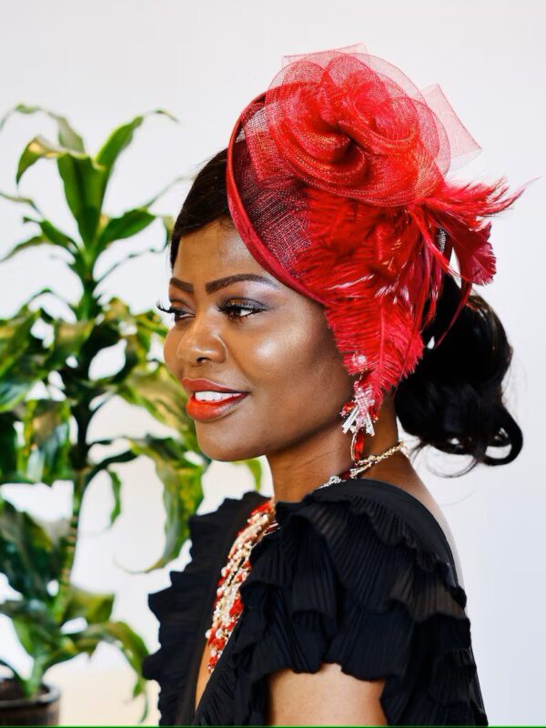 Woman in red hat and black dress.