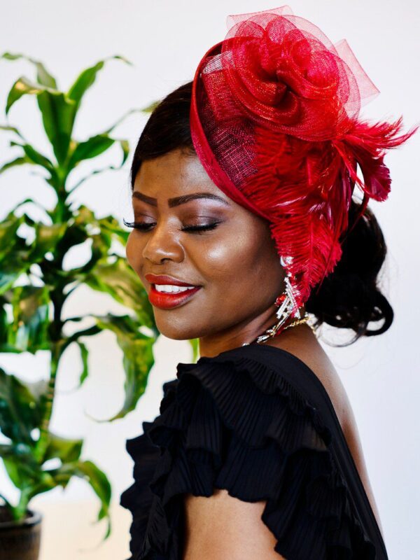 A woman with red feathers on her head.