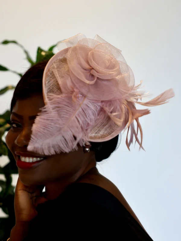 Woman wearing a pink feathered hat.