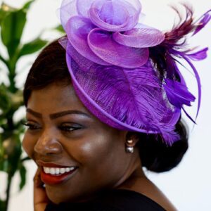 Woman wearing a purple feathered hat.