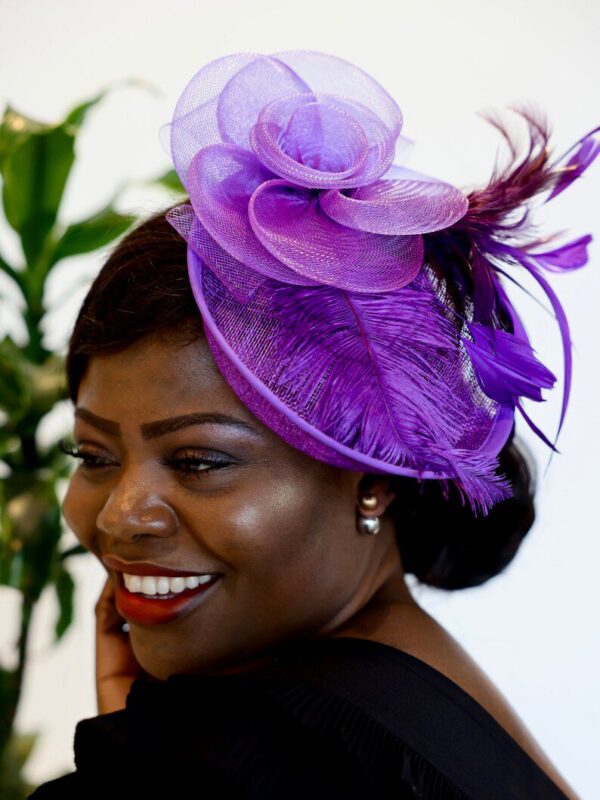 Woman wearing a purple feathered hat.