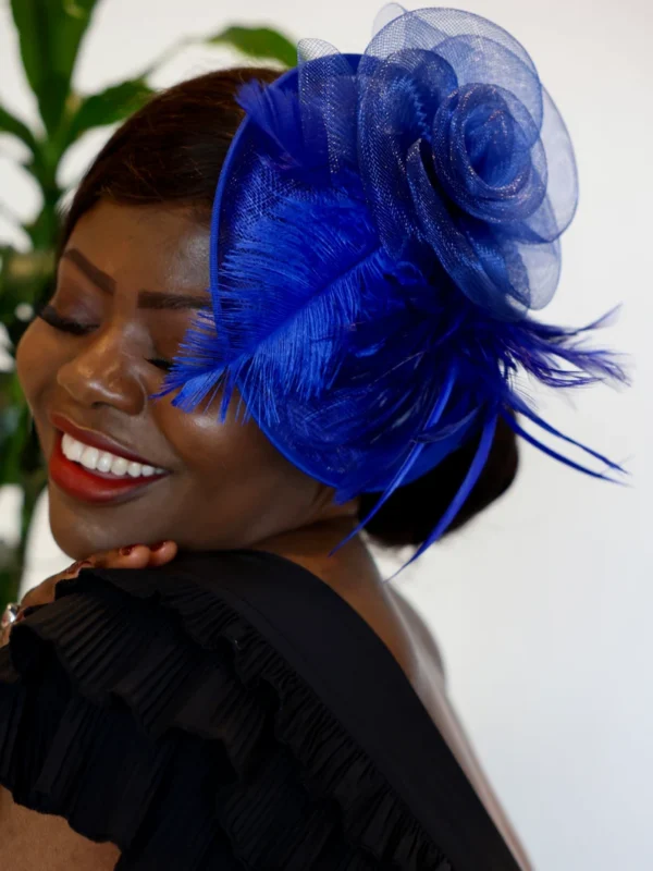 Woman wearing blue feathered hat.