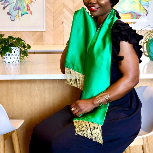 Woman wearing a green graduation sash.