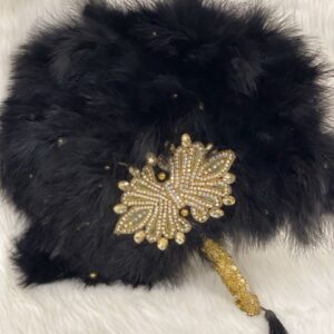 Black feather fan with gold butterfly embellishment.