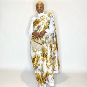 Woman in white and gold patterned saree.