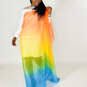A woman in a rainbow colored dress posing for the camera.