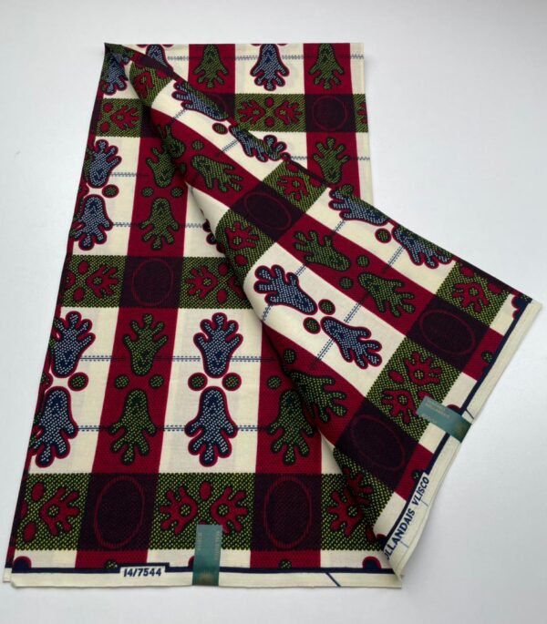 White fabric with red, blue, and green patterns.