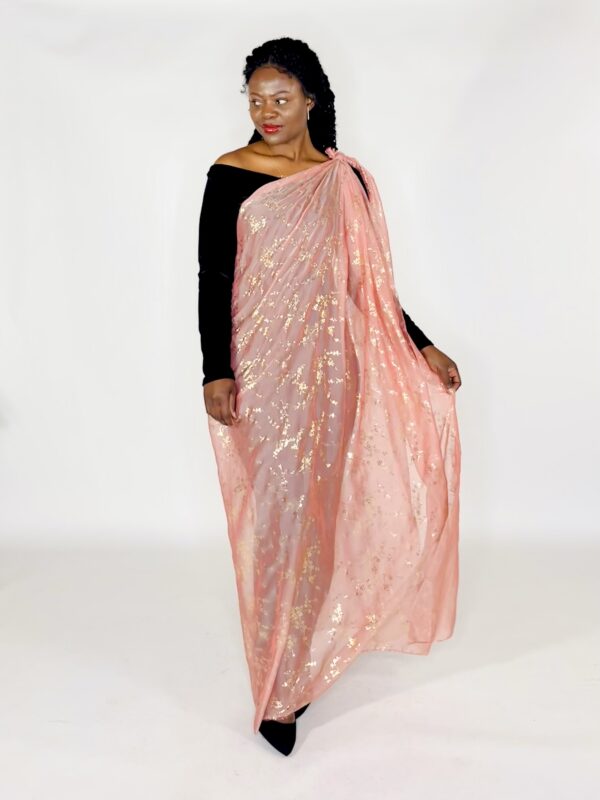 Woman wearing a pink and gold saree.