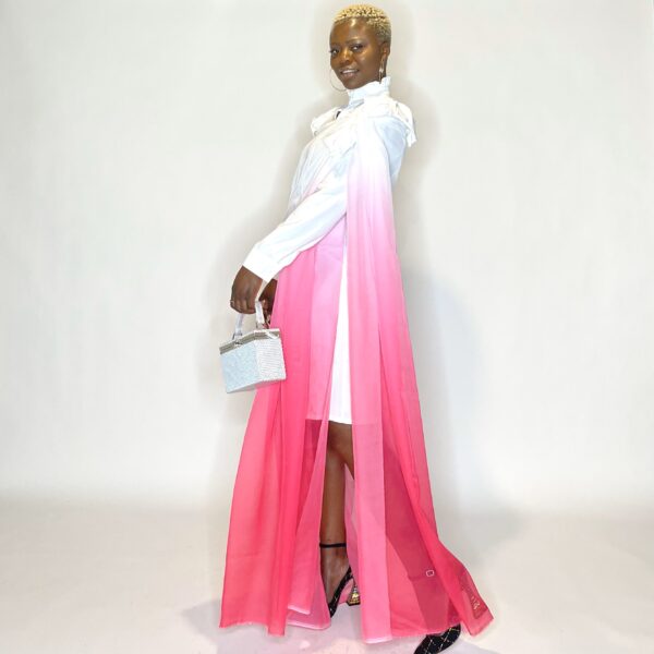 Woman in white dress with pink ombre cape.