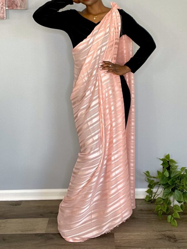 Woman wearing a pink striped saree.