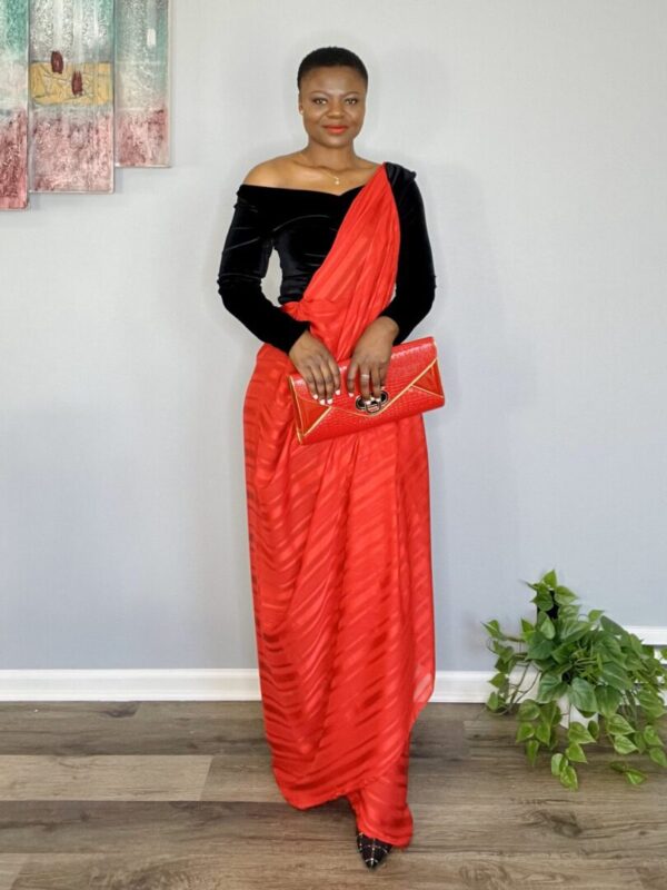 Woman wearing red and black saree dress.