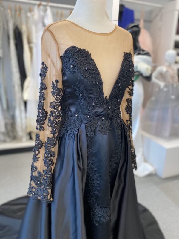 A black dress with lace and beading on it