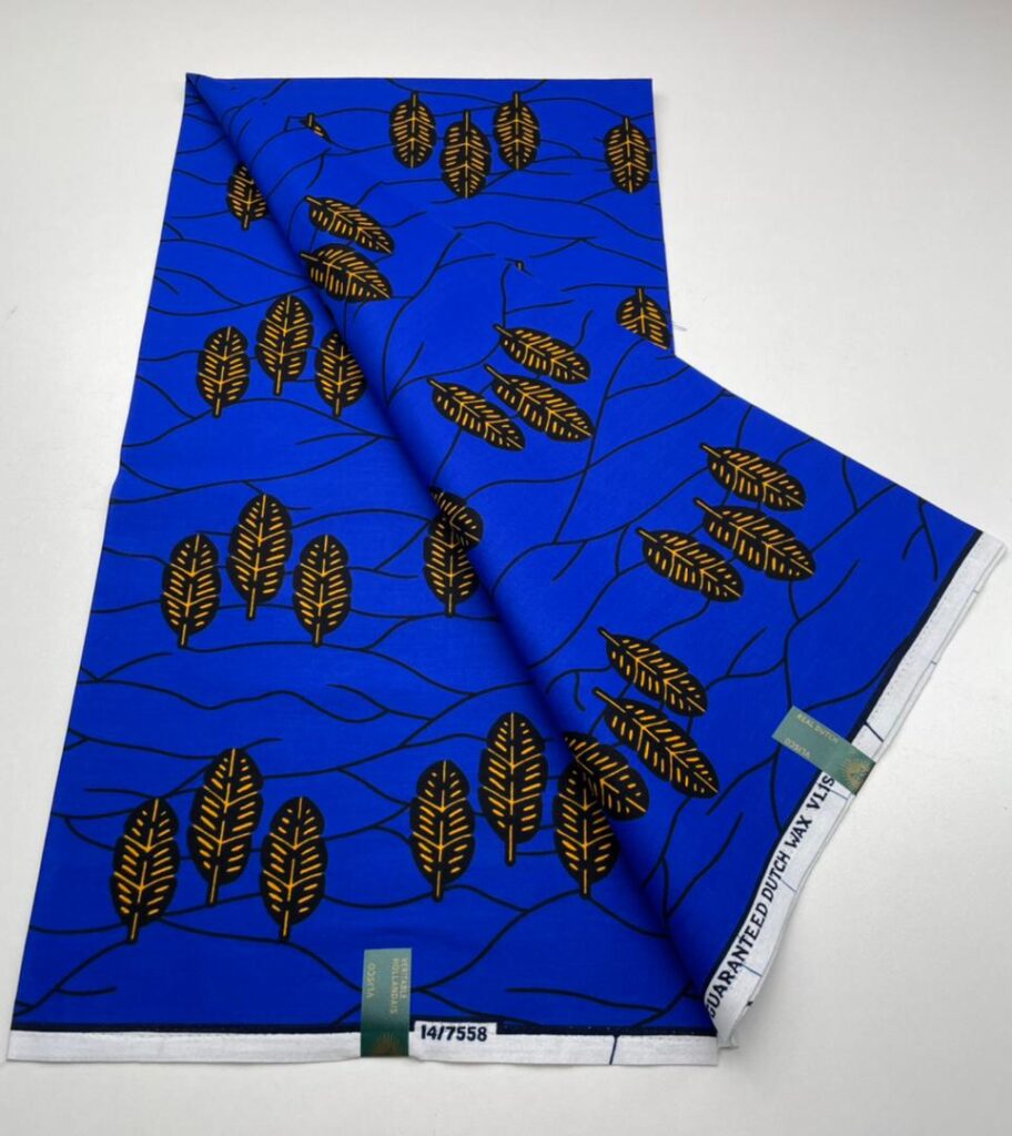 Blue fabric with gold and black leaves pattern.