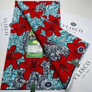 Vlisco fabric with red flowers on blue background.