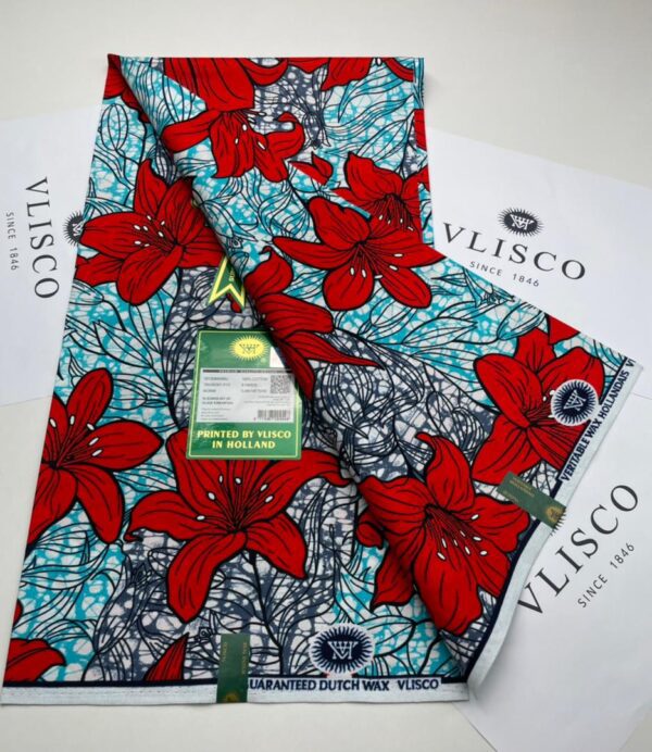 Vlisco fabric with red flowers on blue background.