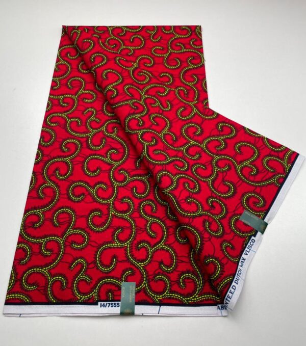 Red fabric with yellow swirl pattern.