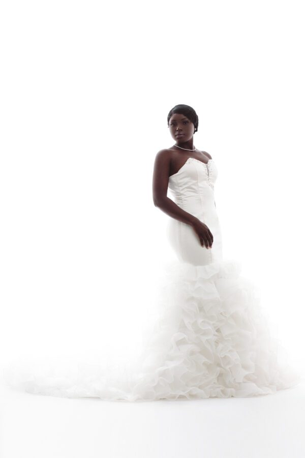 Bride in white wedding gown with ruffles.