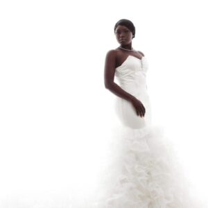 Bride in white wedding gown with ruffles.